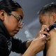 A health worker administers a vaccine during a mass vaccination campaign in Mexico City, Mexico.