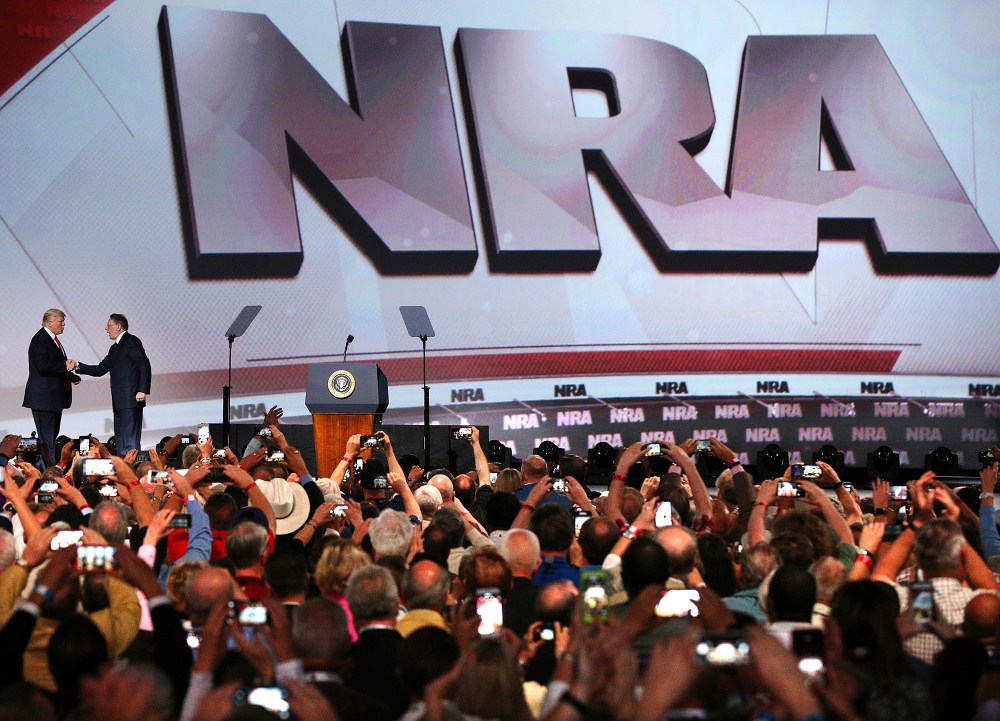 Image: President Donald Trump shakes hands with NRA Executive Vice President Wayne LaPierre