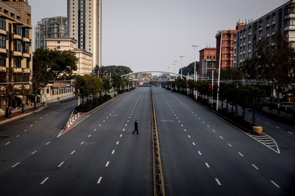 Image: A man crosses an empty highway in Wuhan, China, on Feb. 3, 2020. The coronavirus, which has now spread to several countries, originated in Wuhan.