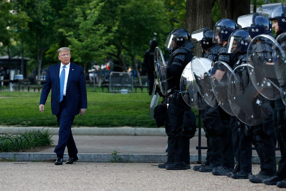 Image: President Donald Trump walks past police in Lafayette Park after visiting outside St. John's Church across from the White House Monday, June 1, 2020, in Washington.