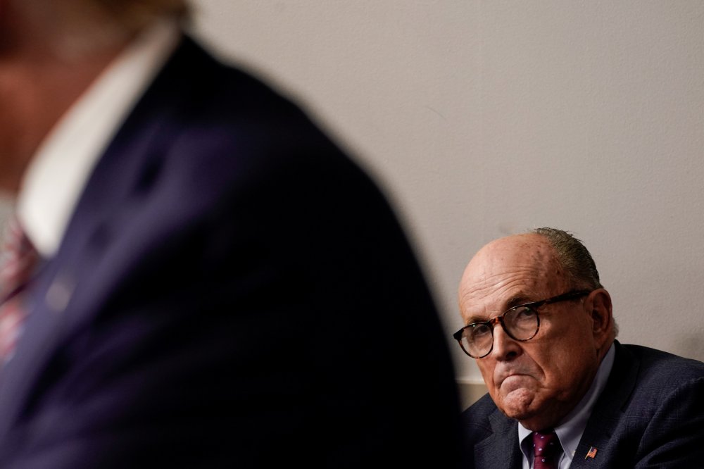 Image: Rudy Giuliani listens to U.S. President Trump speaks to reporters during a news conference