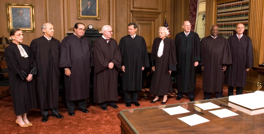 Image: Supreme Court Justices in black robes pose for a picture inside the Cheif Justice Conference Room.