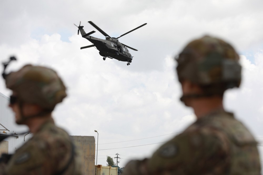 Image: U.S. soldiers stand guard at the K1 Air Base near Kirkuk in northern Iraq, during its handover ceremony