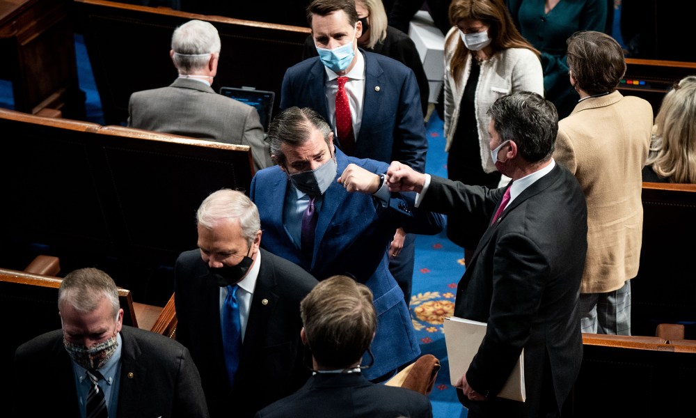 Image: Ted Cruz fist bumps with a house member followed by Josh Hawley.