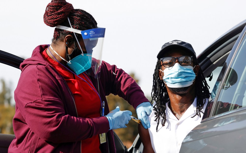 Image: Nurse Dawn Duran administers a dose of the Moderna COVID-19 vaccine to Jeremy Coran during the outbreak of the coronavirus disease (COVID-19), in Pasadena
