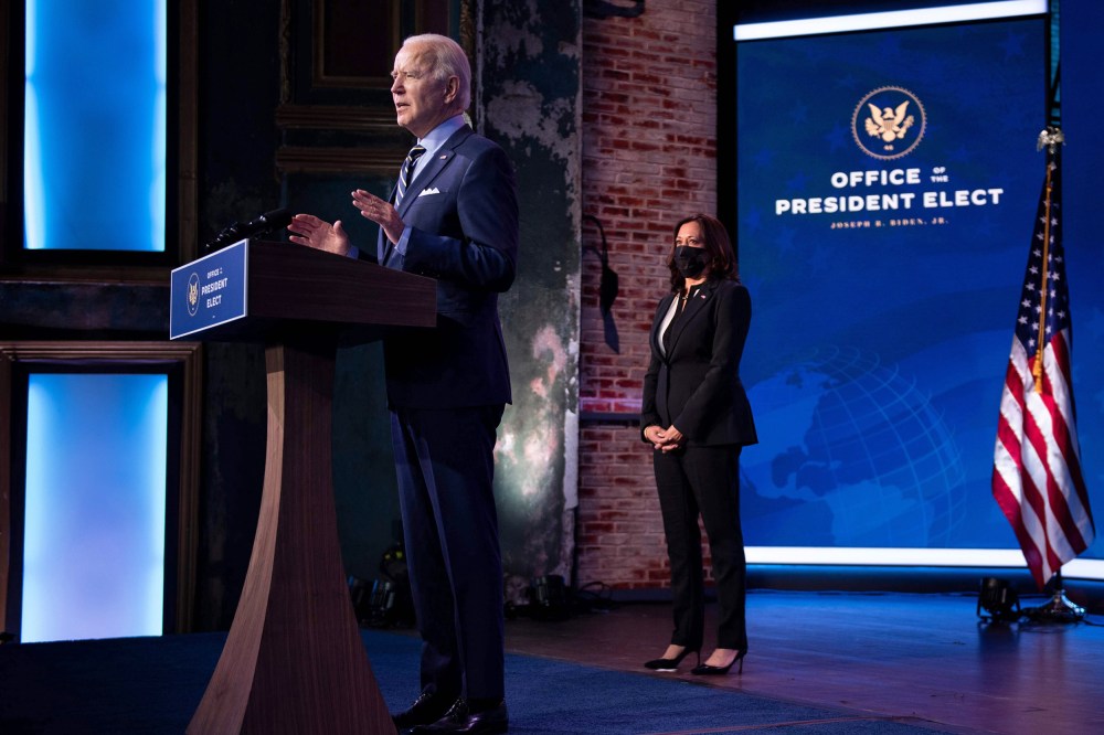 Vice President-elect Kamala Harris listens while as President-elect Joe Biden speaks at the Queen Theater on Dec. 28, 2020, in Wilmington, Del.