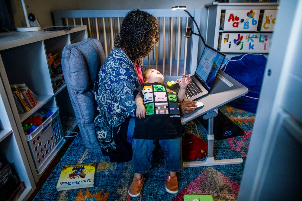 Image:; A mother works at her make shift office set up in her daughter nursery.