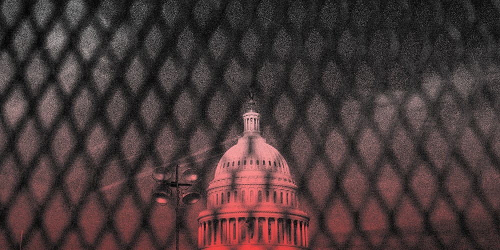 Image: The Capitol dome seen behind a security fence.