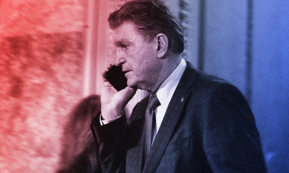Image: Joe Manchin speaking on the phone facing left.