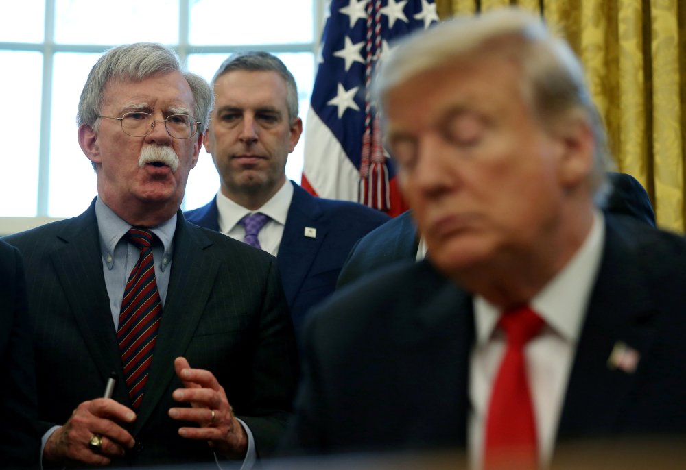 U.S. President Donald Trump listens as his national security adviser John Bolton speaks during a presidential memorandum signing for the "Women's Global Development and Prosperity" initiative in the Oval Office at the White House in Washington, U.S., Febr