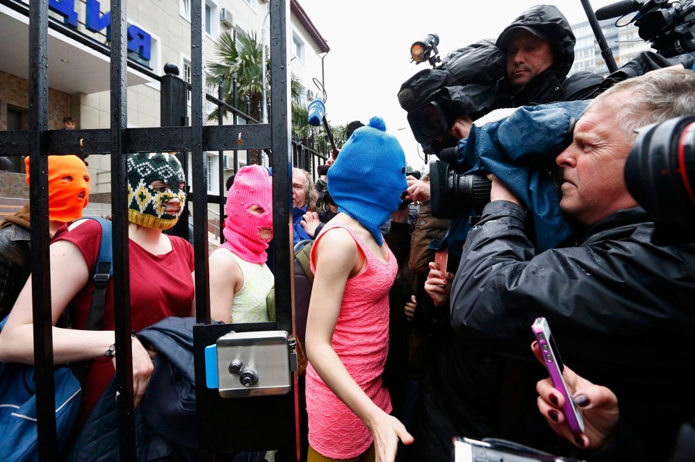 Masked members of Pussy Riot leave a police station in Adler during the 2014 Sochi Winter Olympics, February 18, 2014.
