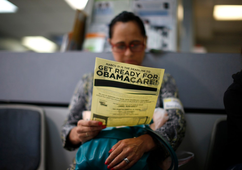 Arminda Murillo, 54, reads a leaflet at a health insurance enrollment event in Cudahy, California March 27, 2014.