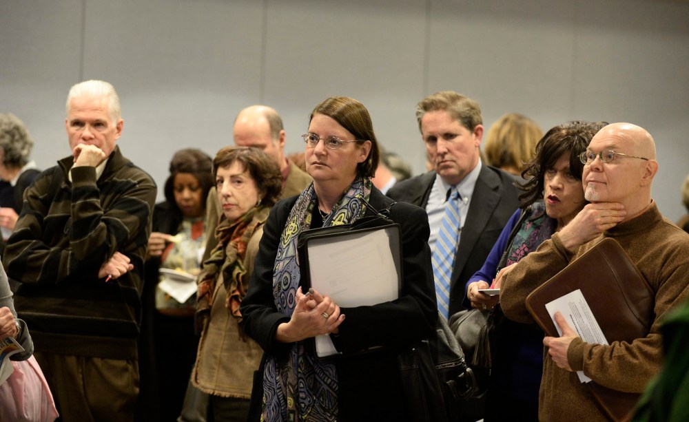 Potential job seekers speak with employers at a job fair in New York, New York, November 20, 2013..