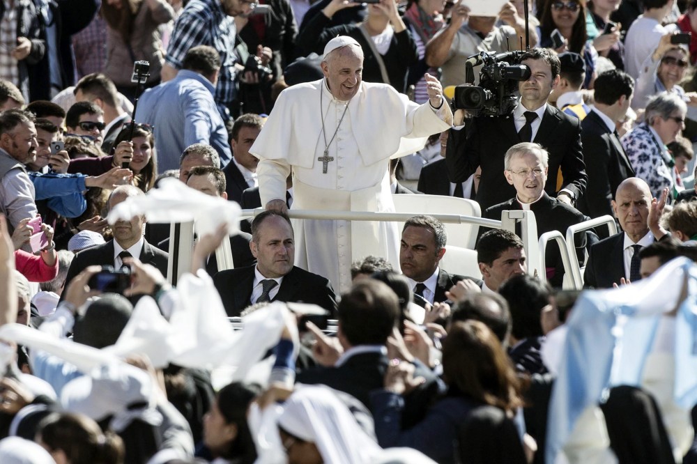 Pope Francis followers as he arrives in St. Peter's Square for his weekly general audience, in the Vatican City on April 22, 2015.