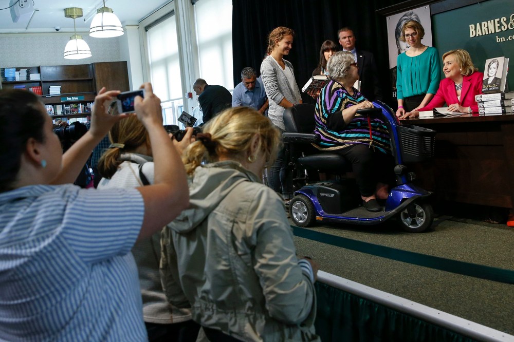 Hillary Clinton speaks with a woman during a signing of her new book "Hard Choices" in New York.