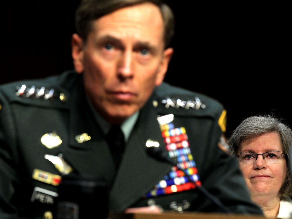 File Photo: U.S. Gen. David Petraeus (L) listens as his wife Holly Petraeus (R) looks on during a confirmation hearing before the Senate (Select) Intelligence Committee June 23, 2011 on Capitol Hill in Washington, DC. (Photo by Alex Wong/Getty Images)