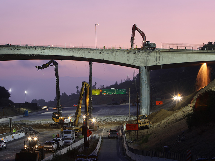 Workers demolish the south side of Mulholland overpass on the 405 freeway during the 53-hour total freeway closure resulting in massive traffic disruptions expected throughout the region on July 16, 2011 in Los Angeles, California.  (Photo by David...