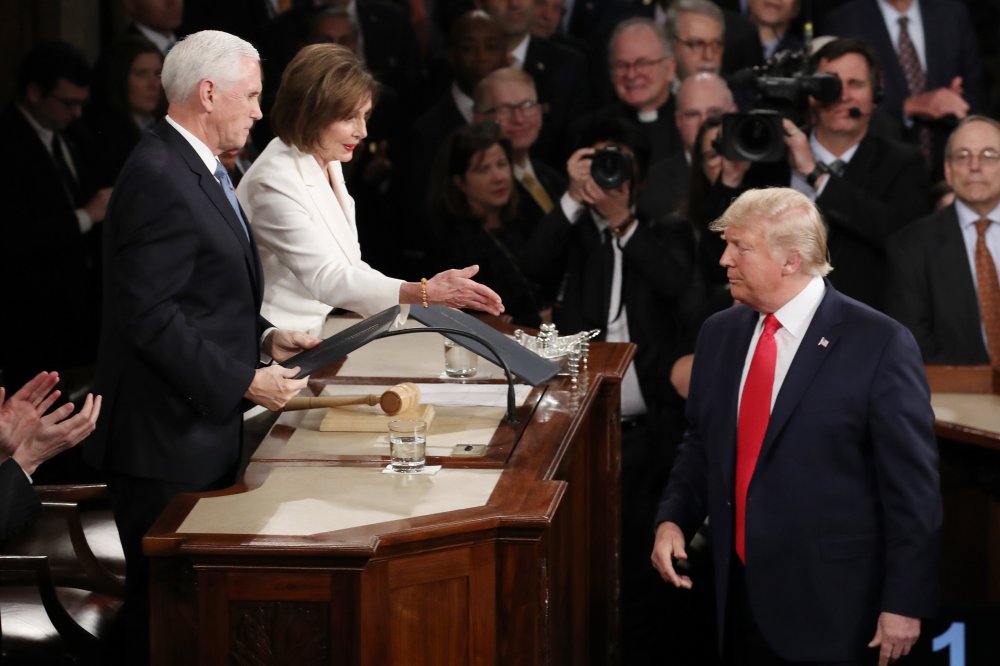 House Speaker Rep. Nancy Pelosi attempts to shake hands with President Donald Trump in the beginning of the State of the Union address as Vice President Mike Pence looks on in the chamber of the U.S. House of Representatives on February 04, 2020 in Washin