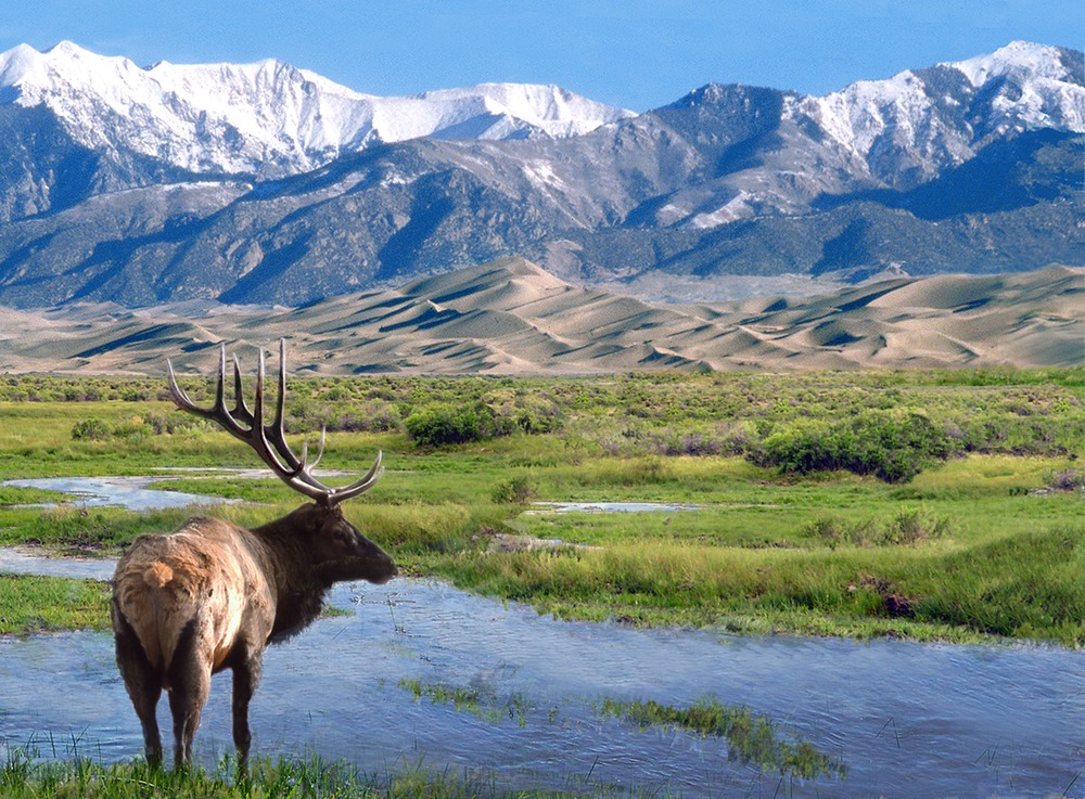 The Sangre de Cristo Mountains, seen here from the Great Sand Dunes National Park, are the backbone of a proposed conservation area announced Friday with a billionaire's pledge to protect 90,000 acres from development.