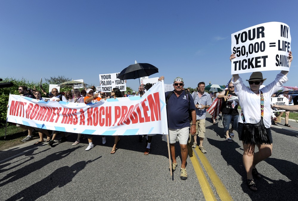 Protesters from MoveOn.org, the Occupy Movement, and the Long Island Progressive march down Meadow Lane at a fundraiser for Republican presidential candidate Mitt Romney on Sunday, July 8, in Southampton, N.Y. Romney's fundraiser at the Southampton...