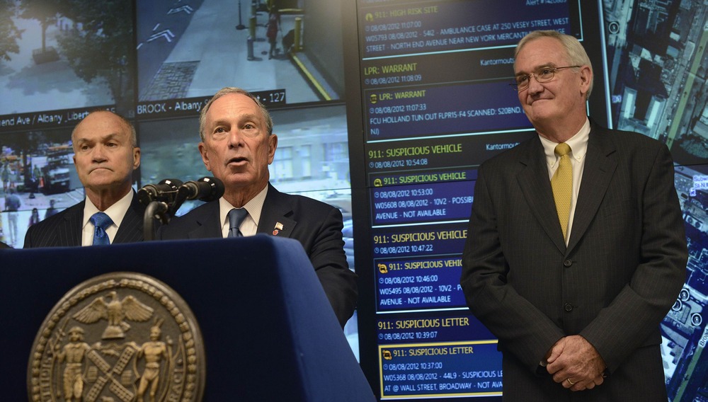 New York City Police Commissioner Raymond Kelly (L) and Microsoft Vice President of Americas Services Mike McDuffie (R) listen as New York City Mayor Michael Bloomberg speaks during a news conference in New York, August 8, 2012.