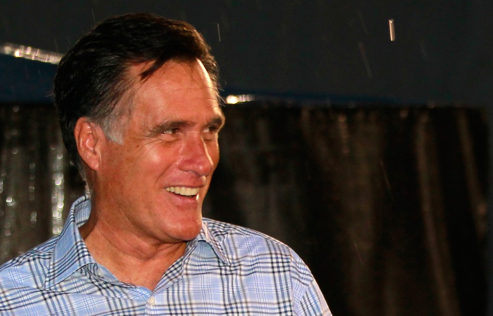 Mitt Romney walks through the garage area during a rain delay before the start of the NASCAR Sprint Cup Series Federated Auto Parts 400 at Richmond International Raceway on September 8, 2012 in Richmond, VA.
