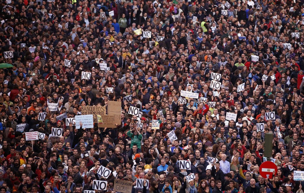 Protestors shout slogans as they fill up Neptuno Square during a demonstration against government austerity measures in Madrid.