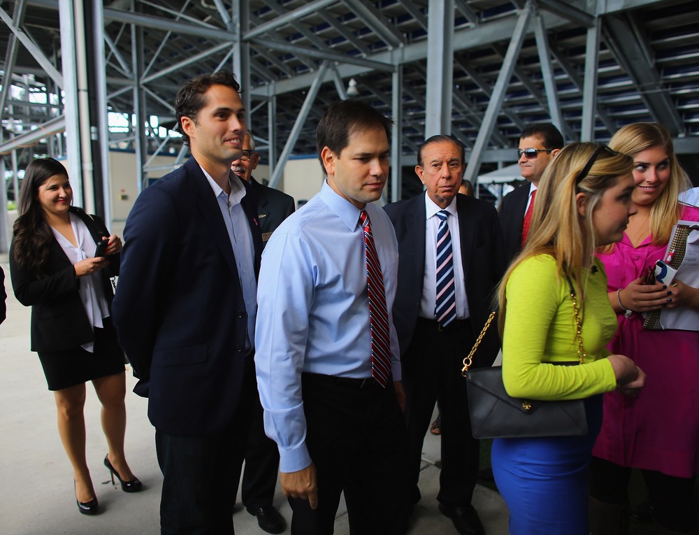 Craig Romney the son of Mitt Romney (L) and Sen. Marco Rubio (R-FL) wait together to enter a building for a Mitt Romney campaign rally at Florida International University in Miami, Florida. on October 12, 2012 in Miami, Florida.