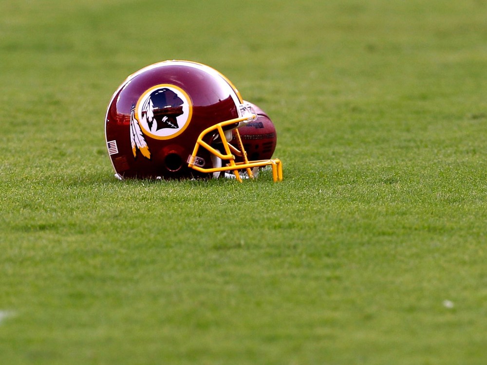 File Photo: A Washington Redskins helmet sits on the field before the start of the preseason game between the Tampa Bay Buccaneers and Redskins at FedExField on September 1, 2011 in Landover, Maryland.  (Photo by Rob Carr/Getty Images, File)