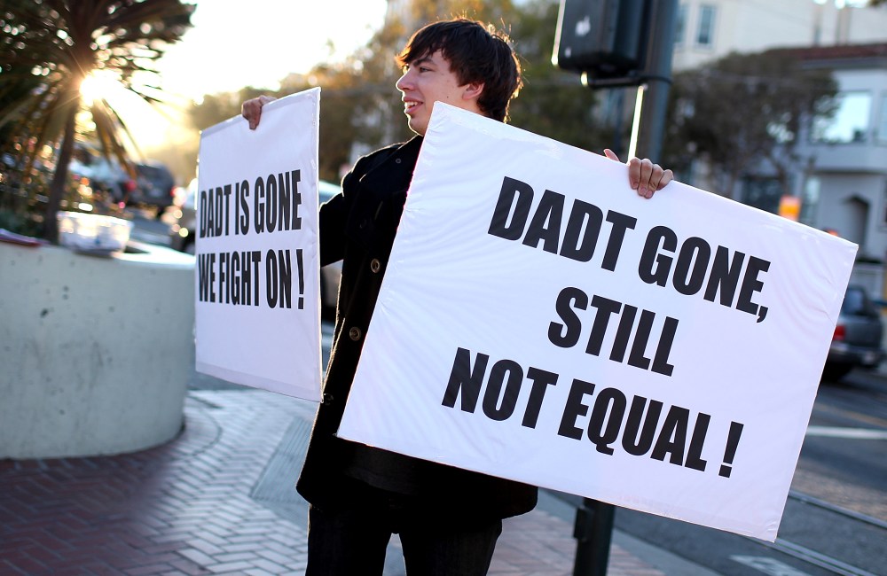 A protestor holds signs as he celebrates the end of "Don't Ask, Don't Tell" but demands equal rights for gays and lesbians on September 20, 2011 in San Francisco, California.