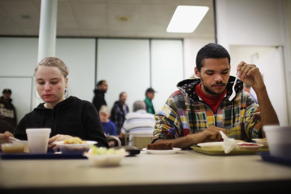 An out of work couple eats lunch at the Central Park United Methodist Church which has a soup kitchen and food pantry on October 20, 2011 in Reading, Pennsylvania.