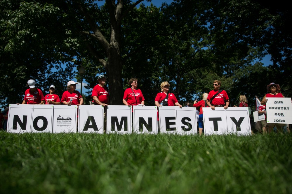 Members of the Rainy Day Patriots, a Tea Party group from Alabama, display a message during the DC March for Jobs in Upper Senate Park near Capitol Hill, on July 15, 2013 in Washington, DC.  (Photo by Drew Angerer/Getty Images)