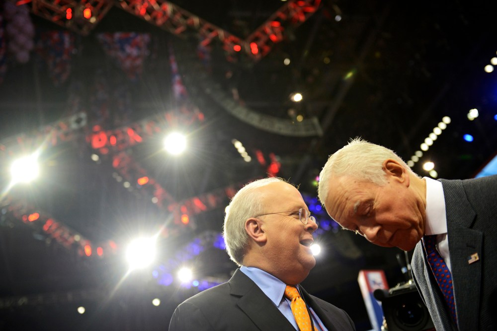 American political consultant Karl Rove and Senator Orrin Hatch from Utah share a word at the Republican National Convention on August 27, 2012.