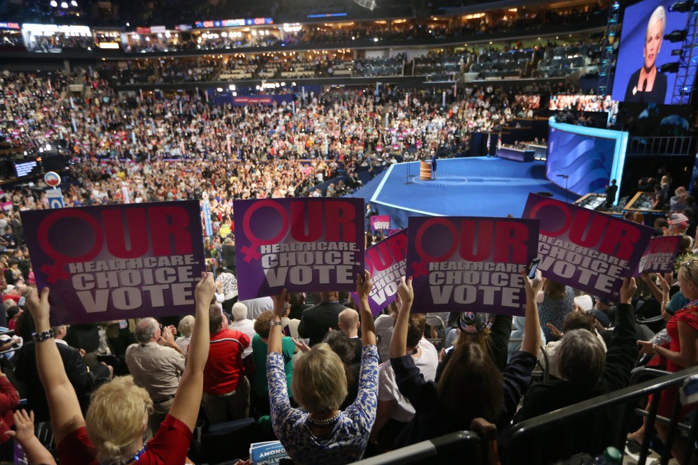 People hold signs as president of Planned Parenthood Federation of America, Cecile Richards, speaks during the Democratic National Convention on September 5, 2012 in Charlotte, North Carolina.