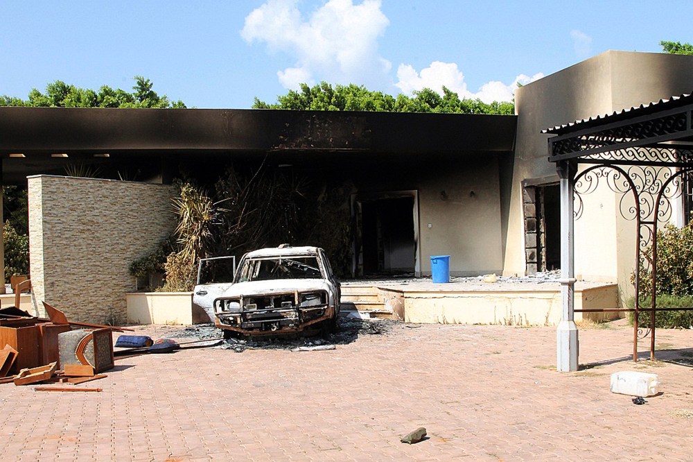 A burnt house and a car are seen inside the US Embassy compound in Benghazi following an overnight attack on the building, Sept. 12, 2012.