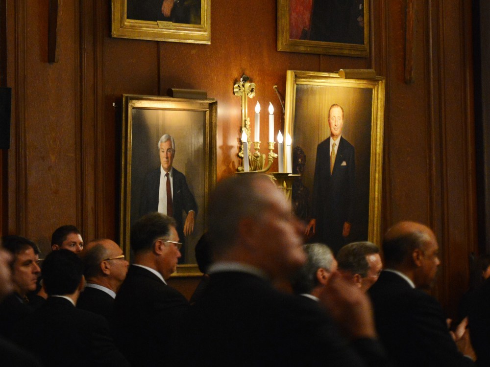 Potential donors listen as Republican presidential candidate Mitt Romney attends a fundraiser