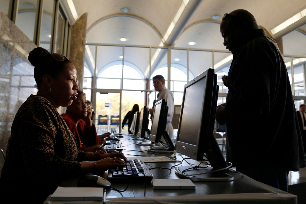 Poll workers help residents during early voting at the Milwaukee Municipal Building Oct. 22, 2012 in Milwaukee, Wisc. (Darren Hauck/Getty)