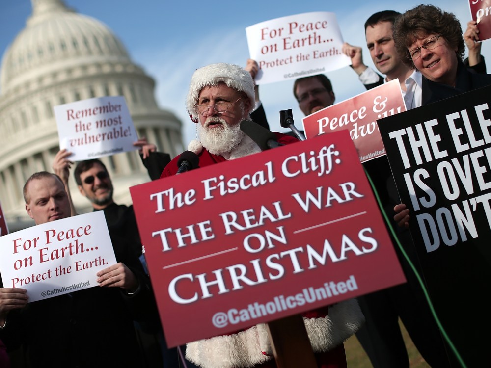 An unidentified man dressed as Santa Claus speaks outside the U.S. Capitol before making his way to Speaker of the House John Boehner's office on December 12, 2012 in Washington, DC. (Photo by Win McNamee/Getty Images)