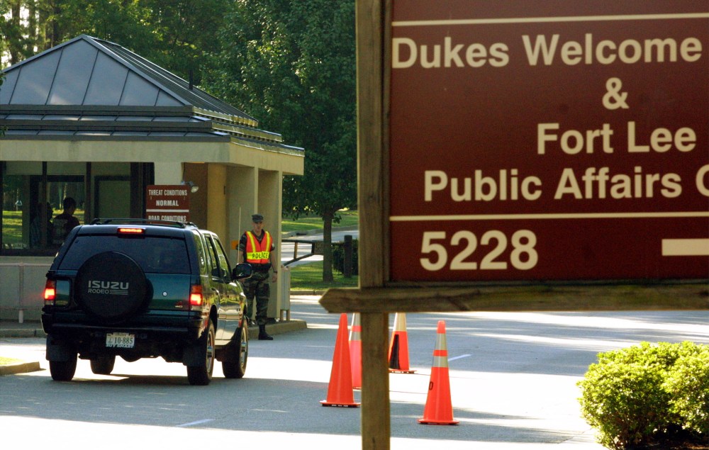 Military personnel guard the entrance to Fort Lee Military Base.