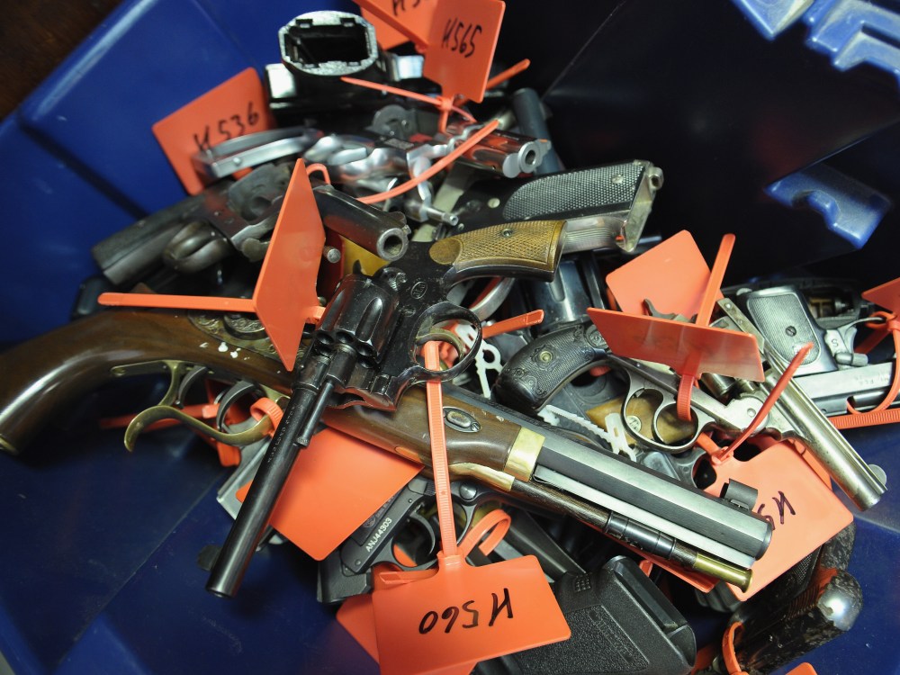 Tagged handguns lay in a bucket during a gun buyback program on March 9, 2013 in Keansburg, New Jersey. (Photo by Michael Loccisano/Getty Images)