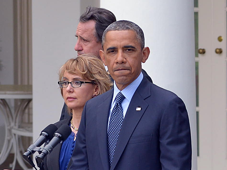 US President Barack Obama, accompanied by former lawmaker Gabrielle Giffords (L),  speaks on gun control and the vote at the US Senate on April 17, 2013, in the Rose Garden of the White House (Photo by Mandel Ngan/AFP/Getty Images)