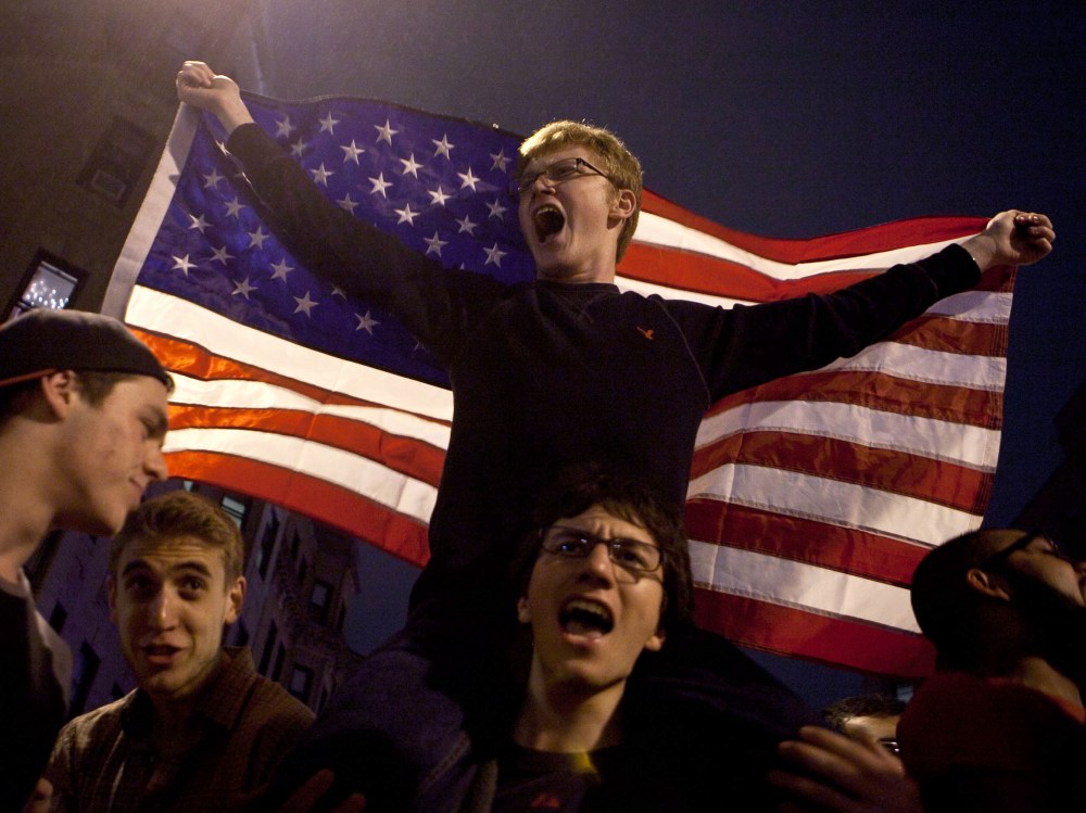 A few of the estimated 200 people who poured onto Hemingway Street in the Fenway neighborhood to celebrate after the announcement earlier of the capture of the second Boston Martathon bombing suspect celebrate April 19, 2013 in Boston, Massachusetts....