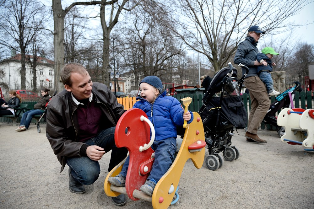 Swede Set Moklint plays with his kid Wilhelm during his paternity leave at Humlegarden park in Stockholm on April 24, 2013.