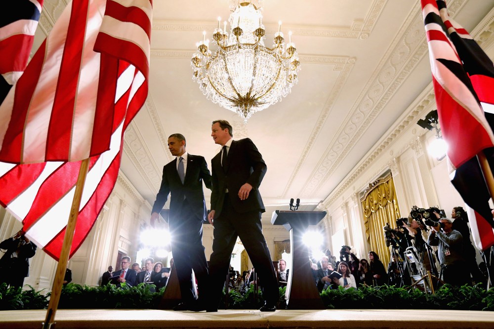President Barack Obama (L) and British Prime Minister David Cameron leave the stage after holding a joint news conference in the East Room at the White House May 13, 2013 in Washington, D.C.
