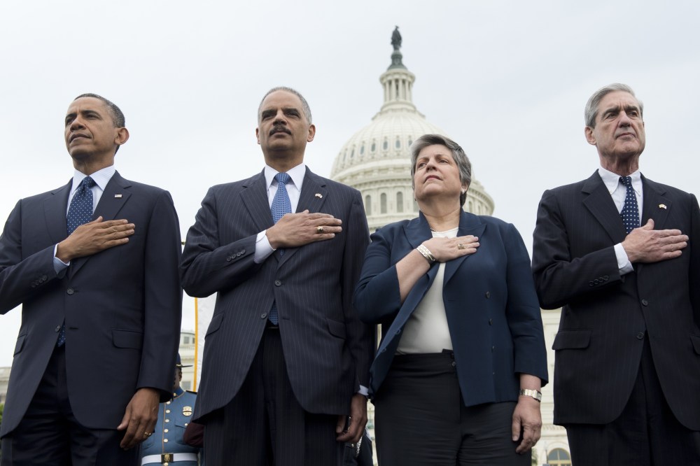 L-R: US President Barack Obama (L), Attorney General Eric Holder, Secretary of Homeland Security Janet Napolitano and Director of the Federal Bureau Investigation (FBI) Robert Mueller stand during the National Anthem at the National Peace Officers...