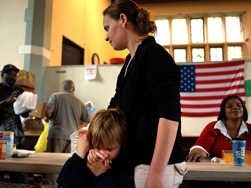 Mlissa Ruella and her son Randy, 3,  wait in line for groceries at the Greater Waterbury Interfaith Ministries on May 20, 2013 in Waterbury, Connecticut. Waterbury, once a thriving industrial city with one of the largest brass manufacturing bases in...