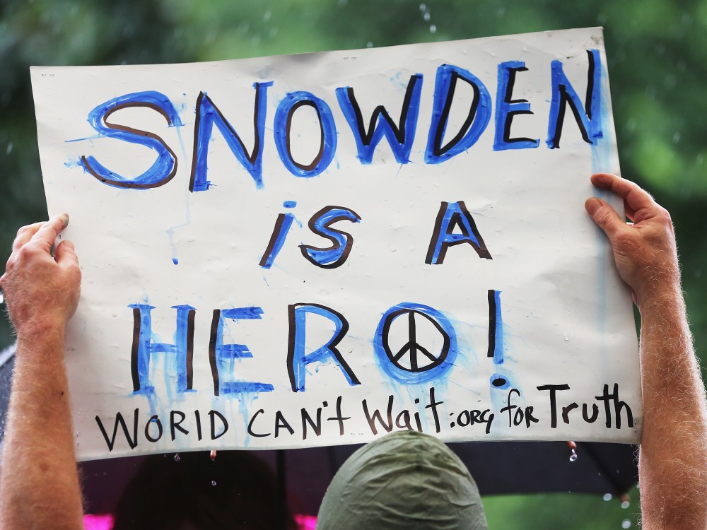 File photo: A supporter holds a sign at a small rally in support of National Security Administration (NSA) whistle-blower Edward Snowden June 10, 2013 in New York City.  (Photo by Mario Tama/Getty Images)