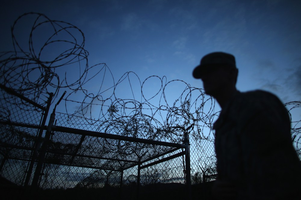 A Public Affairs Officer escorts media through the currently closed Camp X-Ray on June 27, 2013 in Guantanamo Bay, Cuba. (Joe Raedle/Getty)