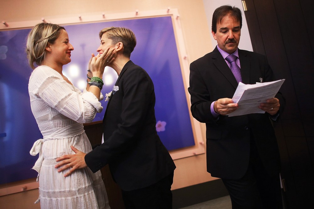 Stefanie Berks and Daisy Boyd embrace after their marriage ceremony in New York, June 28, 2013.