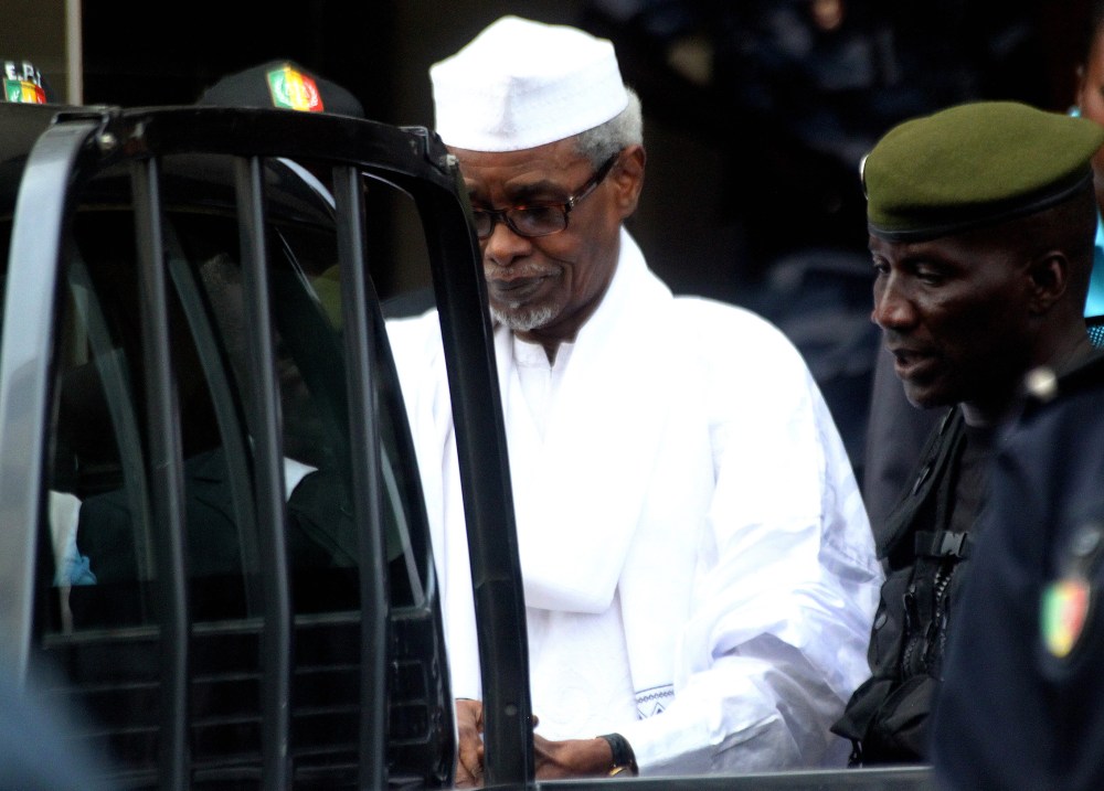 Former Chadian dictator Hissene Habre, charged with genocide, war crimes, torture and crimes against humanity, is escorted by military officers after being heard by judge on July 2, 2013 in Dakar. (Photo by STRINGER/AFP/Getty)